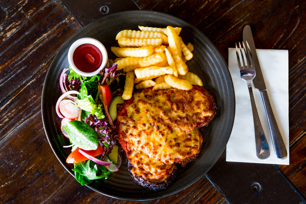 Italian,Chicken,Parmigiana,With,Chips,And,Garden,Salad,Served,At